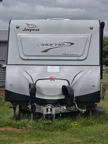 Reviewer's shiny Jayco caravan parked on grass after being cleaned with the 4WD care package.