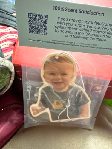 Customer's Custom Air Freshener with a photo of a smiling baby, still in its original packaging.