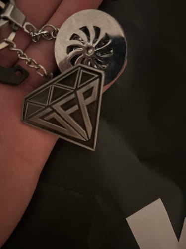 Customer holding their Diamond Keychain, showing a close-up of the metallic diamond-shaped charm.