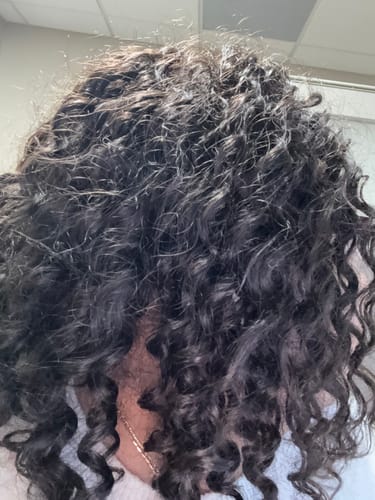 Close-up of a reviewer's Human Crochet Hair Deep Wave after five weeks, showing full, slightly frizzy curls.