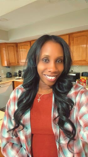 Customer smiling while wearing the long, wavy Outre Quick Weave Half Wig - TANNER.
