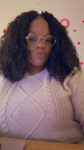 Reviewer showing off their voluminous installation of Burmese Water Curly Human Crochet Hair with a neat center part.