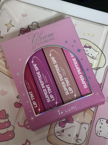 Reviewer's Holiday Hues Bundle in its pink packaging, showing the four different shades of lip tint.