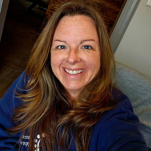 A happy reviewer smiles in a close-up selfie submitted with their review for the High Potency Black Seed Oil.