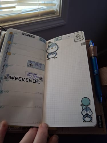 Reviewer's planner decorated with cute penguin stickers from the Planner Subscription for January.
