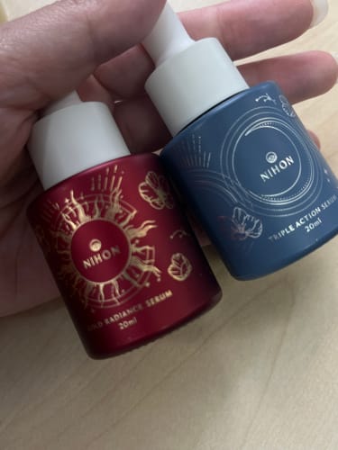 Reviewer holding the two pretty, limited edition bottles of the Radiance & Renewal Duo Serum.