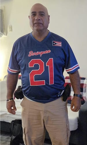 A customer wearing the blue Puerto Rico Heritage Custom Football Jersey with the number 21.