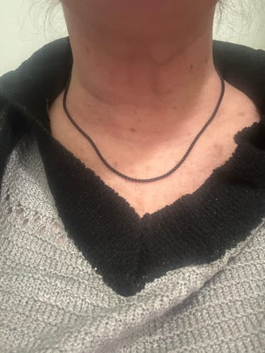 Close-up of a reviewer wearing the thin 2mm Round Box Link Chain around their neck.