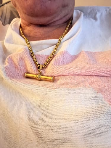 Customer wearing the XL T-Bar Necklace, showing a close-up of the thick gold chain and T-bar pendant.