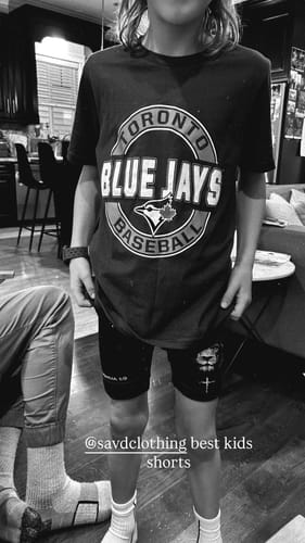 Reviewer's photo showing a child in black shorts with a logo, mentioned in their review.