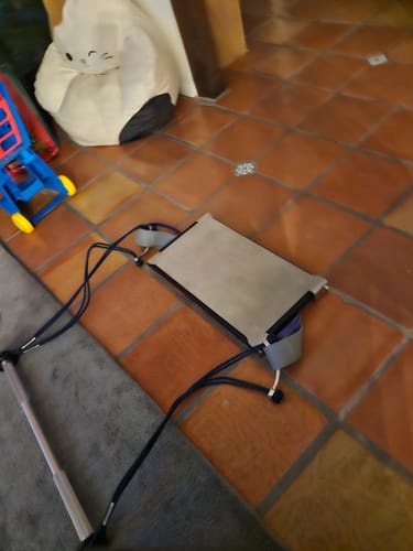 A reviewer's CyberBar and CyberPlate resistance system on a tiled floor in a home.