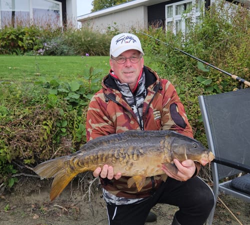 Recensent houdt een grote karper vast die is gevangen met de SUPERCRUSH MEGA CARP METHOD MIX.