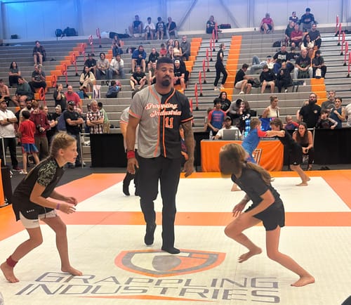 Customer's daughter wearing the Girls Performance Shorts in a grappling stance at a jiu-jitsu match.