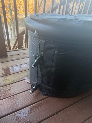 Customer's black IcePod on a wooden deck, showing the two attached drain valves.