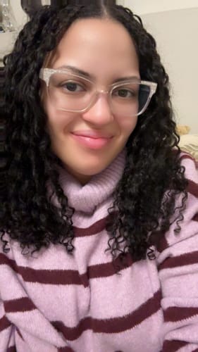Reviewer showing their soft and curly Burmese Water Crochet Hair installed.