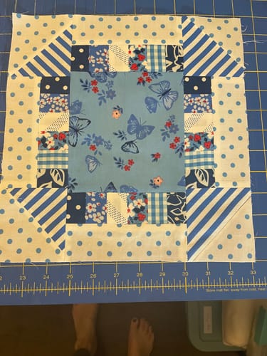 Customer's completed quilt block made with the Early Christmas Pattern Bundle, featuring blue and white fabrics.