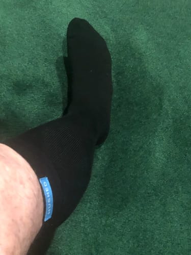 Customer showing the fit of a black Performance Eucalyptus Compression Sock on their lower leg.