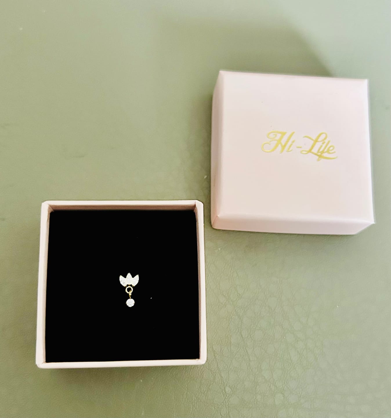 Customer photo review of Tiny Dangle Lotus Labret Piercing - Titan