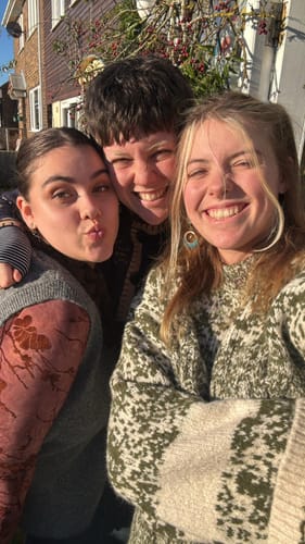 Reviewer smiling with friends outdoors, wearing the Bohemian pattern earrings.