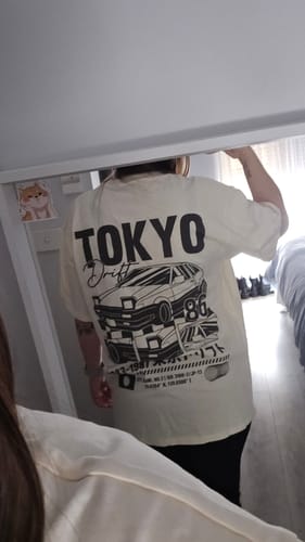 Reviewer taking a mirror selfie showing the back graphic of their off-white Tokyo Drift T-Shirt.