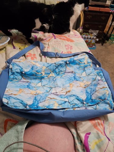 Customer's handmade tote bag using the Parisian Blue solid fabric for the straps and sides, paired with a blue and gold marbled fabric.