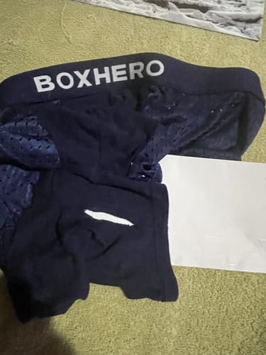 Customer's photo showing a pair of dark blue boxer briefs with a logo on the waistband.