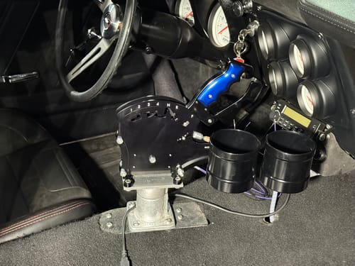 Customer's dual billet cup holder attachment installed on an Operator Series shifter in a car's interior.