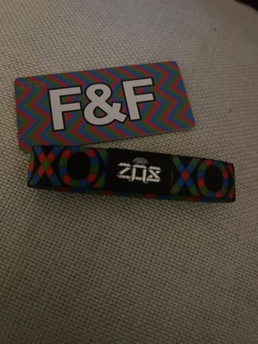 Customer's F&F Spectra Interactive Bracelet and matching colorful card lying on a textured surface.