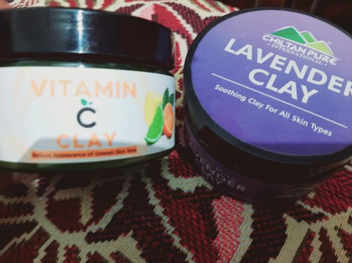 Customer's purple tub of Chiltan Pure Lavender Clay next to a tub of Vitamin C Clay.