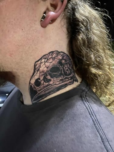 Customer's fresh neck tattoo of a detailed bird skull, done using the Painless Tattoo Numbing Cream.
