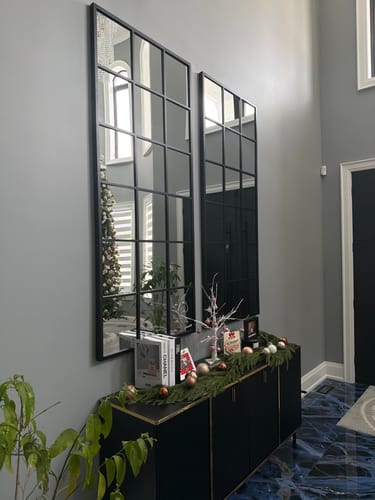 Customer's two Modern Black Grid Wall Mirrors hung vertically side-by-side above a decorated console table.