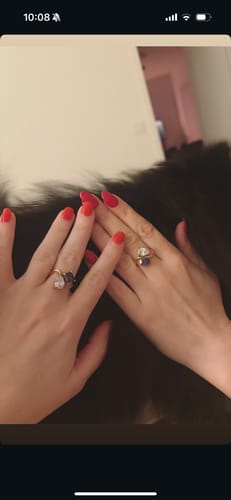 Two customers showing their Navae Birthstone Rings worn on their middle fingers, highlighting the product fit.