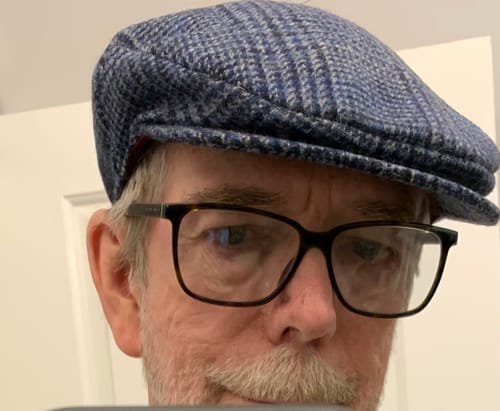 Close-up of a customer wearing the blue tweed Vintage Cap.