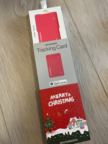 Reviewer showing the red SPOTMINDERS Tracking Card in its festive 'Merry Christmas' packaging.