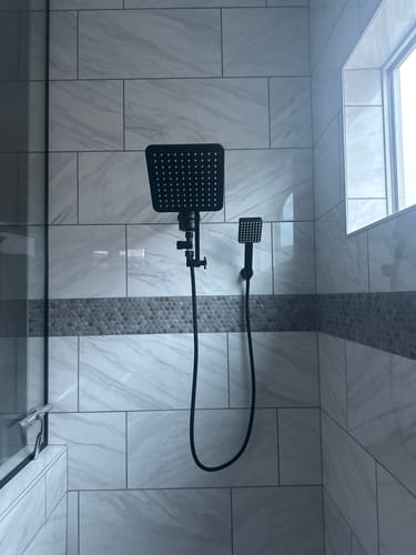 Customer's black Square Dual Shower Head Set installed against a light-colored tiled shower wall.