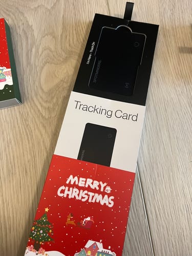 Customer shows the SPOTMINDERS Tracking Card in its original packaging with a festive Christmas sleeve.