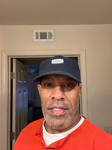 Reviewer showing the comfortable fit of the dark Big Relaxed Cap.
