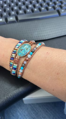 Customer's wrist showing the Natural Turquoise & Jasper Wrap Bracelet with its beaded bands and large turquoise stone.