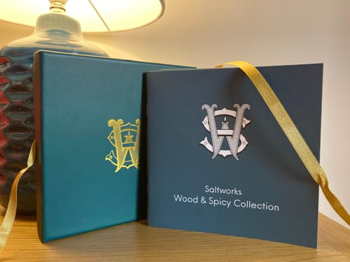 Customer's Wood & Spicy Set packaging, showing the teal presentation box and collection booklet.