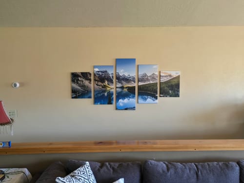 Reviewer's 5-panel Moraine Lake At Dusk canvas print hanging on a living room wall above a couch.