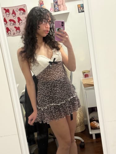 Reviewer taking a front-view mirror selfie in the 2000s Milk Leopard Mesh Babydoll Mini Dress.