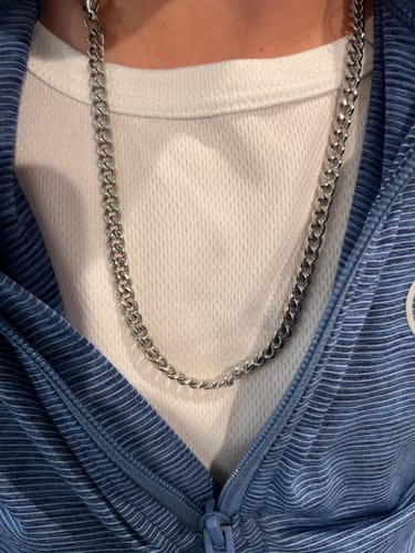 Close-up of a customer wearing the silver 5mm Cuban Link Chain over a white t-shirt.