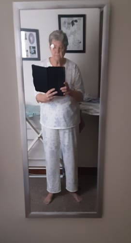 Reviewer wearing a comfy two-piece pajama set made from the Blue Flower Patterns cotton fabric.