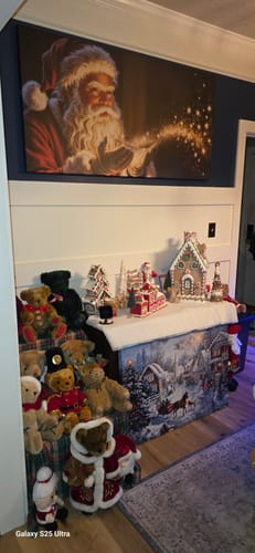 Customer's Vintage Santa Claus Christmas Wall Art hung on a wall above a festive display of teddy bears and other decorations.