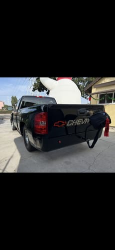 Customer's Stroud spring parachute mounted on the back of a black Chevrolet truck in a driveway.