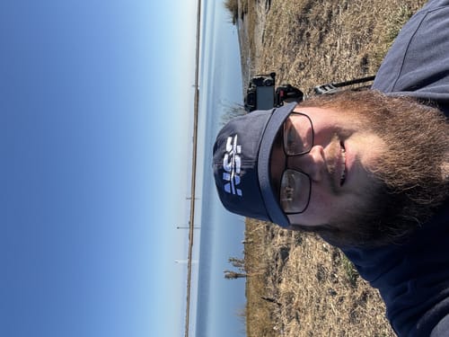 Customer taking a selfie outdoors while wearing the blue NSF Hat.