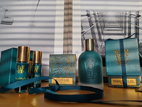 Customer's Surfari fragrance collection in teal and gold packaging, including a full-size bottle and other items.