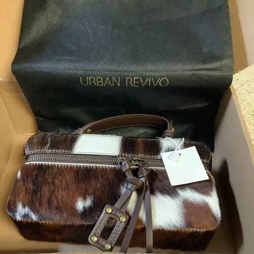 Reviewer's Fluffy Handle Shoulder Bag with a brown and white fur pattern shown inside its box.