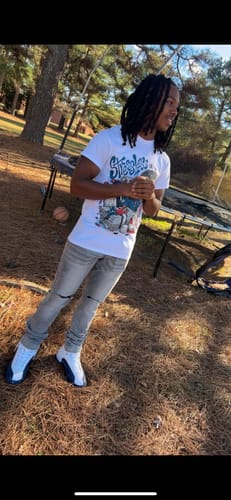 Customer wearing the snug-fitting French Blue 12s DopeSkill T-Shirt outdoors with grey jeans and matching sneakers.