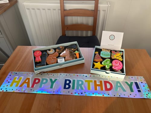 Reviewer's Horse Riding Deluxe Biscuit Box with decorated equestrian biscuits on a table for a birthday celebration.